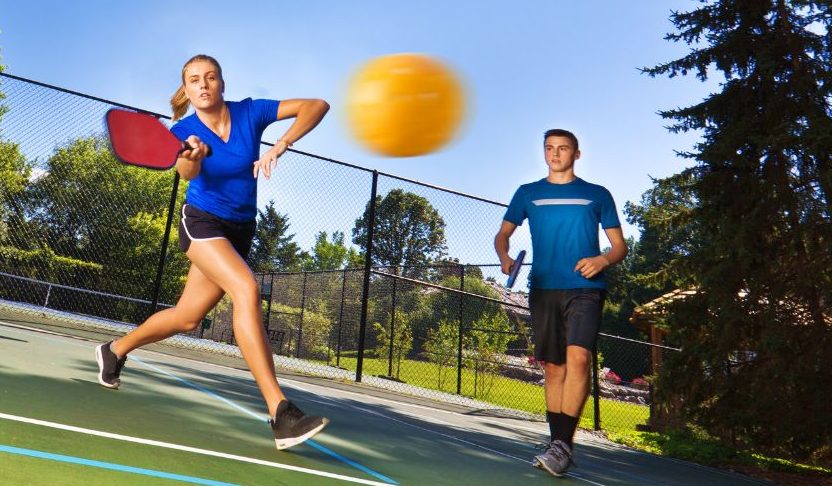 Young Man and Woman Pickleball Player Playing Pickleball in Court